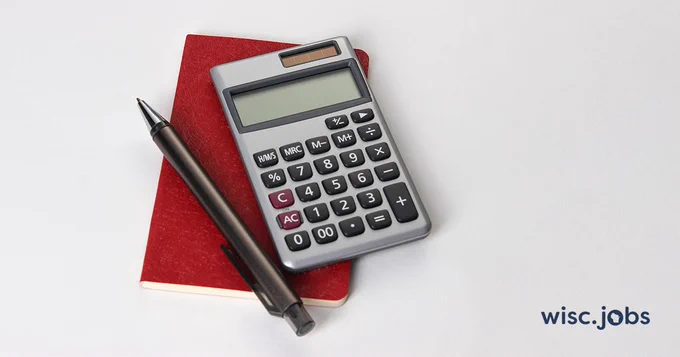 Image: pen and a calculator on a notebook; Wisc.Jobs