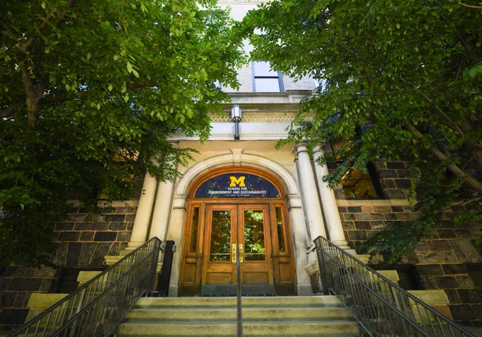 The dana building entrance surrounded by trees. 