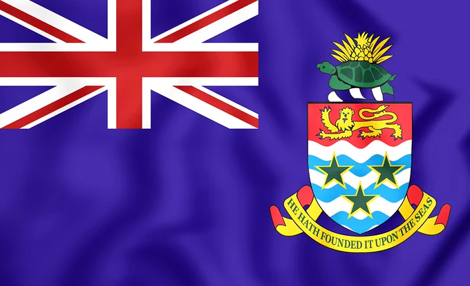 Flag of the Cayman Islands featuring a blue field with the Union Jack and a shield with a turtle and three stars.