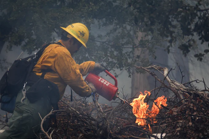 Firefighter igniting a pile burn on the Cleveland National Forest.