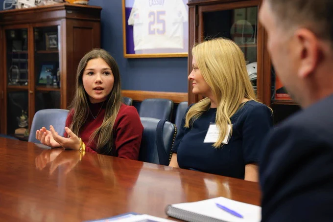A young member of the PI community shares her story with a staffer from Sen. Bill Cassidy's office.