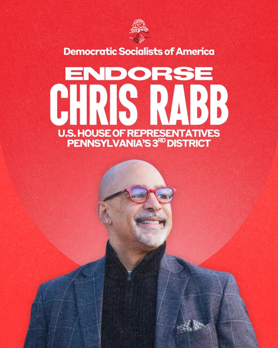 Democratic Socialists of America endorse Chris Rabb, U.S. House of Representatives, Pennsylvania's third district. Chris Rabb, a Black man with a shaved head and a neat salt-and-pepper beard, looks to the side. He has a warm, confident smile. He is wearing red glasses, a black quarter zip sweater, and a warm grey suit jacket.