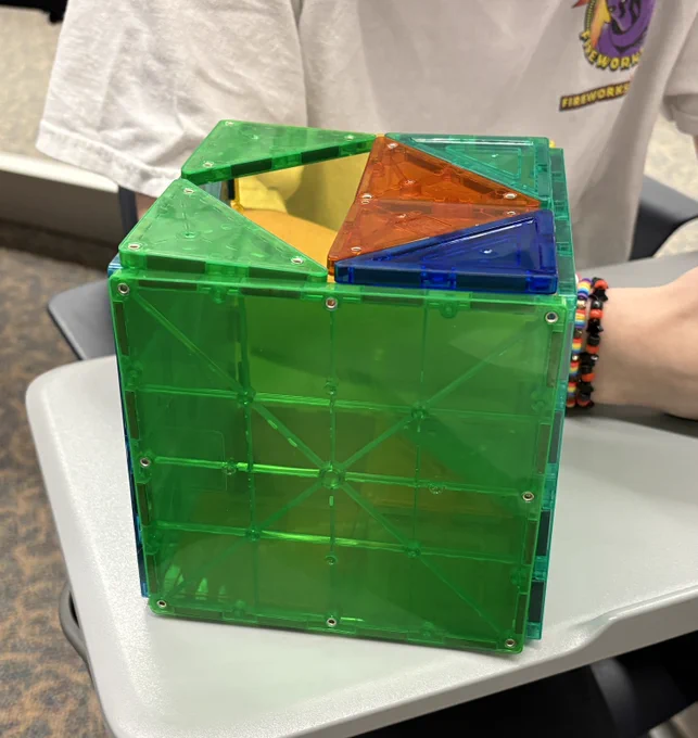 Structure #2: Large triangles of different colors form a crescent. Small tiles sit on top of each large triangle. The triangles all form the color of the rainbow.