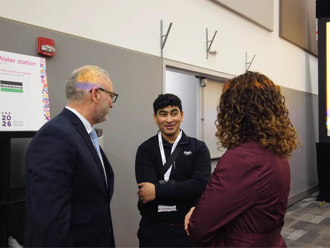 A photo of Ontario Tech President and Vice-Chancellor, Dr. Steven Murphy, and Ontario Tech's EDGE CEO, Jennifer Alsop, speaking with another event attendee at the CNA conference.
