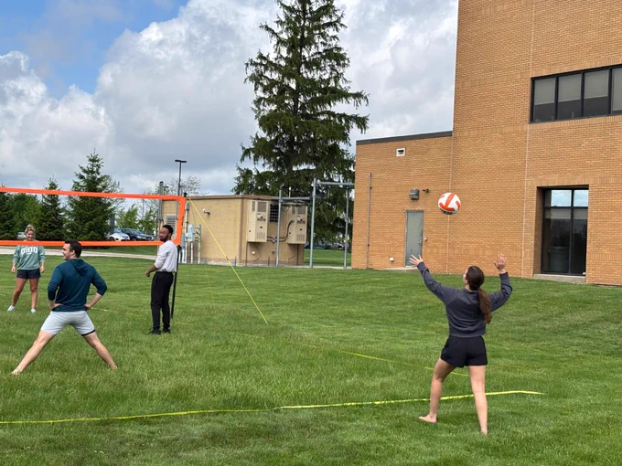 A student prepares to serve a volleyball during the tournament on the Dublin campus.