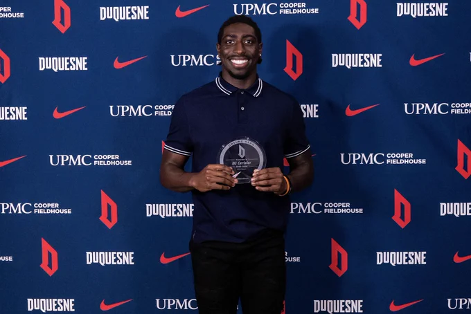 DJ holding Unsung hero trophy smiling