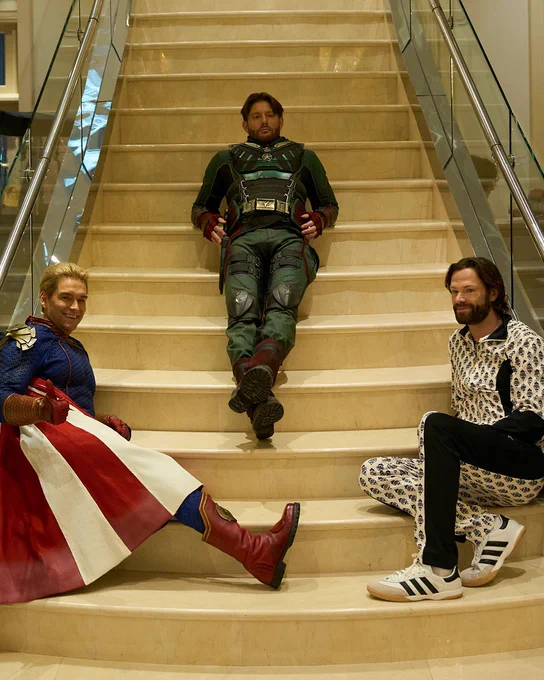 Antony Starr as Homelander, Jensen Ackles as Soldier Boy and Jared Padalecki as Mr Marathon sit on a stairway while filming Season 5, Episode 5 of The Boys