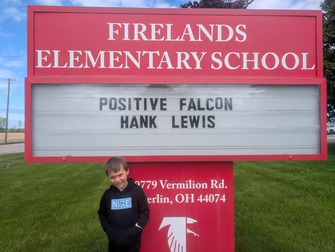 Student in front of sign 