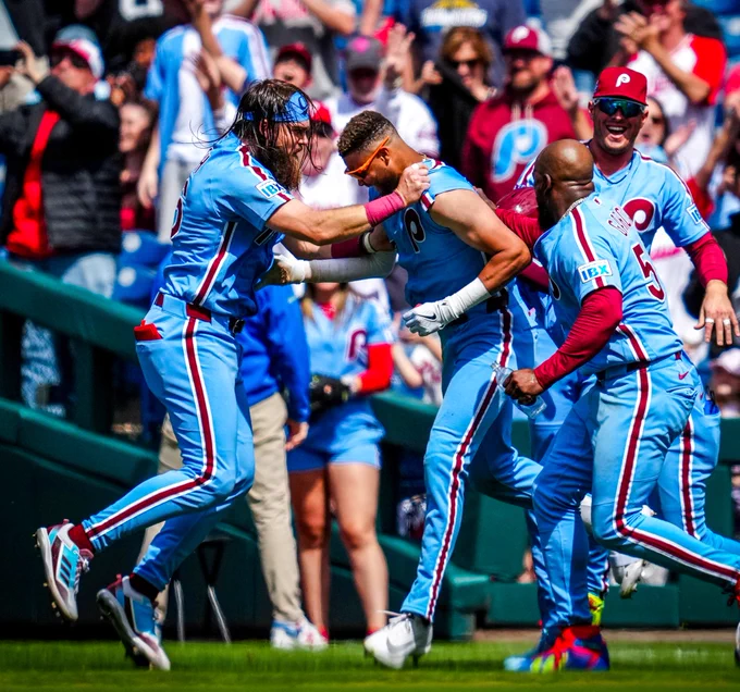 The Phillies celebrate a walkoff win in their powder blue uniforms