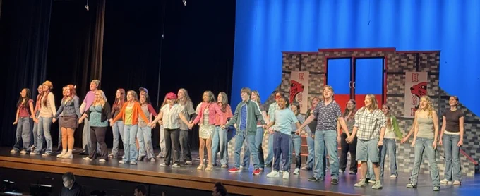 Picture of the high school musical with students singing