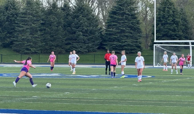 Picture of girls soccer kicking a ball