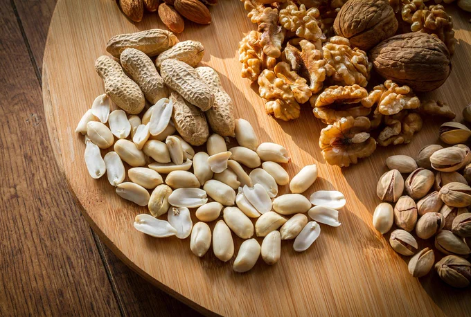 A board with lots of different types of nut on it