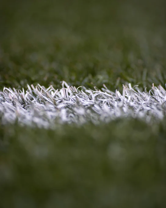 A picture of the Wembley Stadium pitch up close.