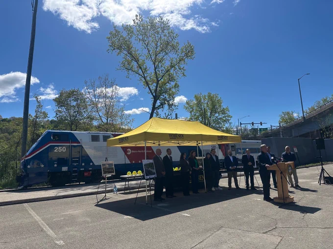 Federal, state, and local officials gather under a tent at the Derby train station to announce the start of construction to renovate four stations along the Metro-North Waterbury Branch Line. 