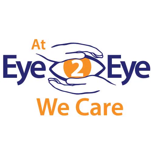 Eye2Eye Logo: The logo shows the words "At Eye2Eye We care" Eye2Eye is written in navy blue. We care is written in orange. The number 2 is surrounded by an image of an eye. Two hands surround the eye. 