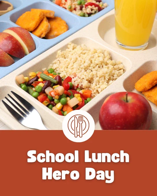 A school lunch tray with cooked veggies, rice, apple, orange slices, and a glass of orange juice. "School Lunch Hero Day" text overlaid.