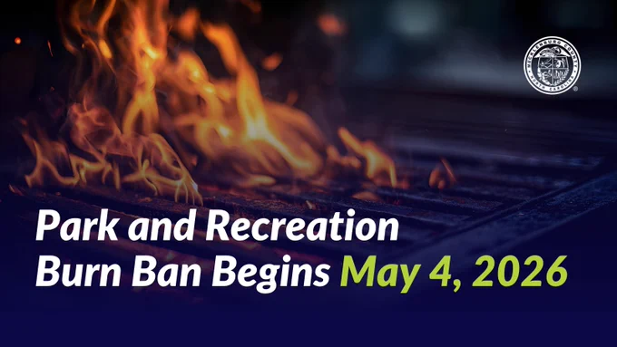 Flames rising from a grill with the text "Park and Recreation Burn Ban Begins May 4, 2026" displayed in white and green.