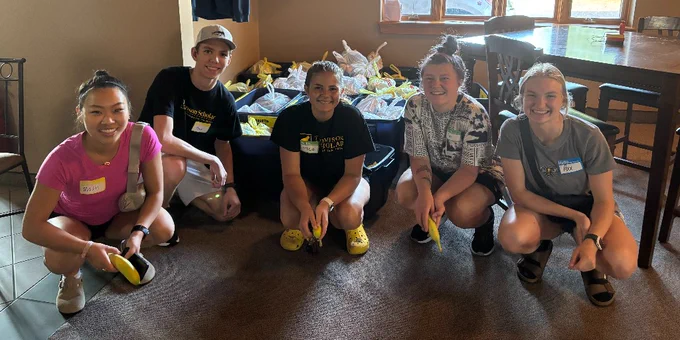 A group of Thompson Scholars pose together at a volunteer event. 
