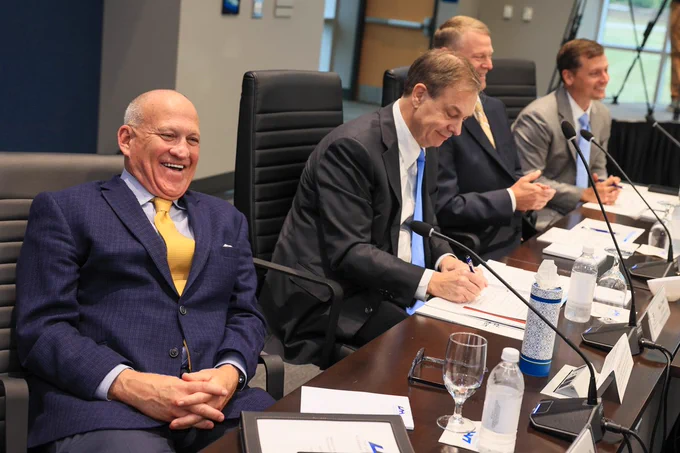 People seated at a conference table.