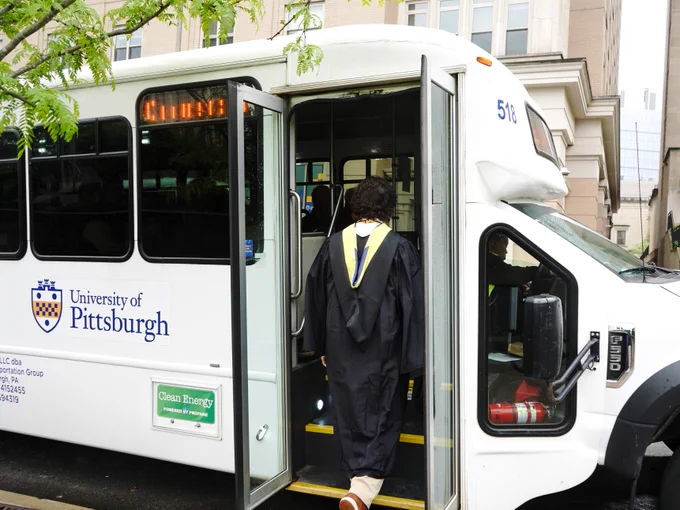 Pitt Shuttle pickup up graduate on the way to Commencement