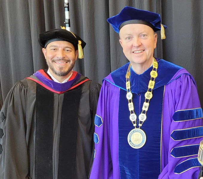 Florida Education Commissioner Anastasios Kamoutsas and Dr. Jeff Allbritten stand in graduation regalia.
