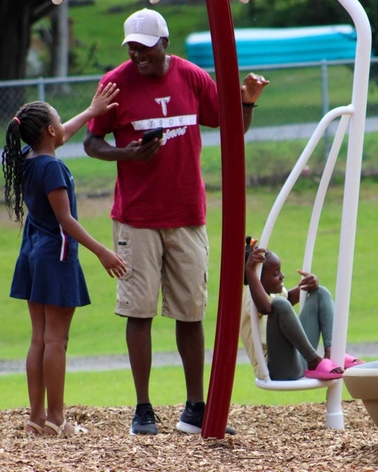 Father with 2 daughters on a playground