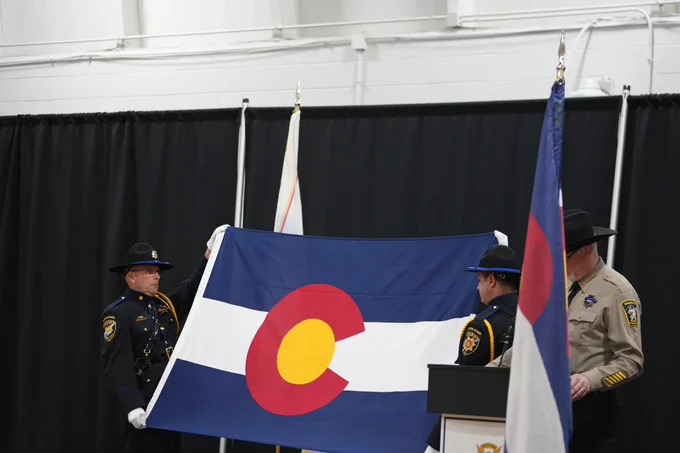 Members of Honor Guard holding Colorado Flag