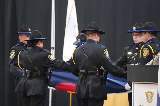 Members of Honor Guard foldingColorado Flag