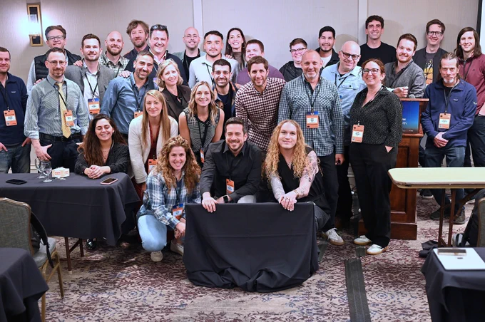 A group photo of the Duda team in a ballroom of a hotel