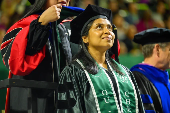 Ohio University doctoral student receives a hood at commencement.
