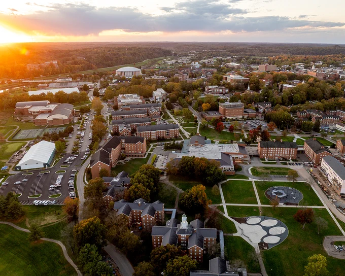 Drone photo showing the sun setting over Ohio University's campus