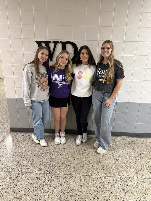 Four students smiling.