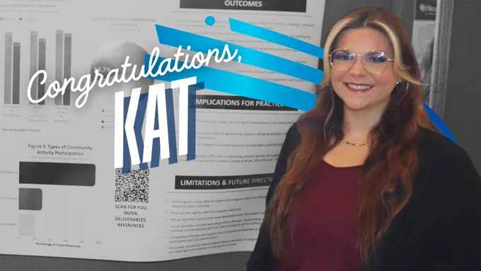 A professionally dressed woman standing in front of a large poster with various charts and text printed. "Congratulations, Kat" and DRTC swoosh logo.