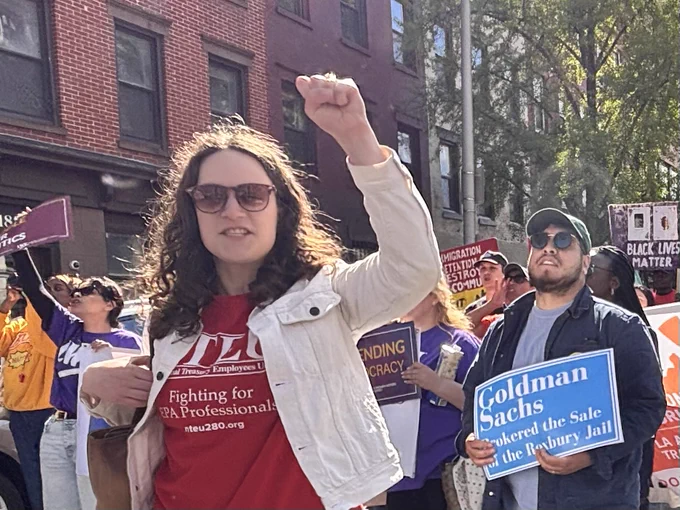 Eleana holds her fist up at the May Day march