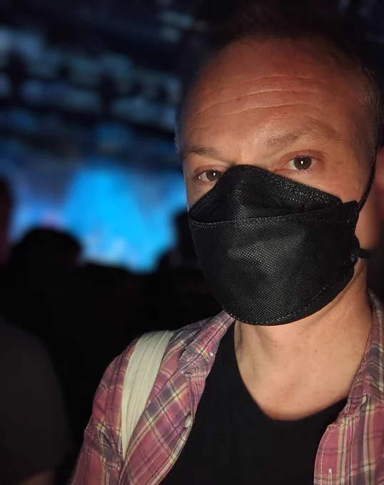 Man wearing black respirator mask.