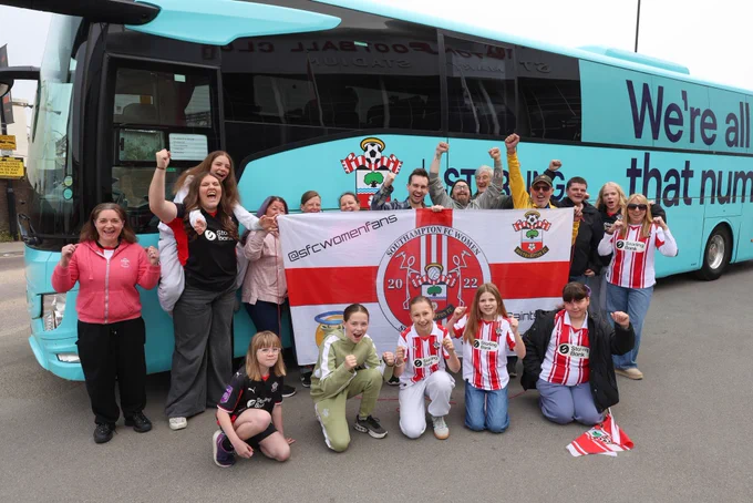 Southampton FC Women’s supporters pose outside a Starling branded coach before their trip up to Nottingham Forest