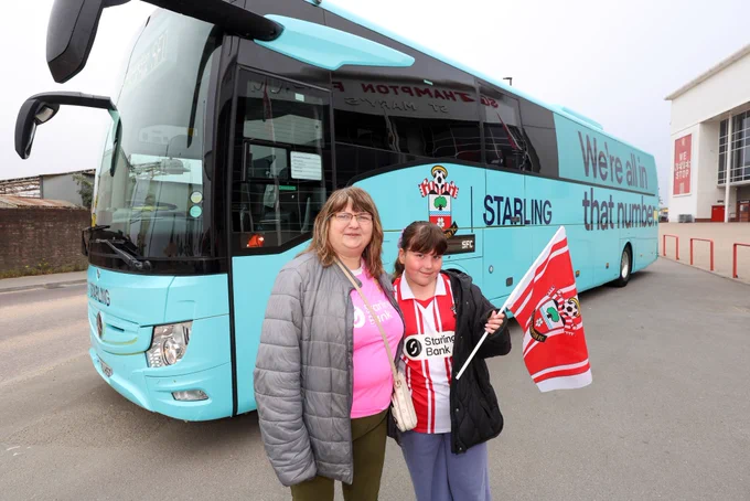 Southampton FC Women’s supporters pose outside a Starling branded coach before their trip up to Nottingham Forest