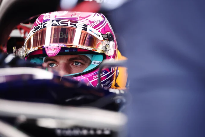 A close-up shot of Max Verstappen’s eyes peering out from under a racing helmet.