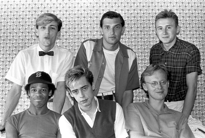 Black-and-white promotional photo of Haircut One Hundred circa 1982, featuring Nick Heyward front centre with band members in a classic Pelican West-era studio portrait.