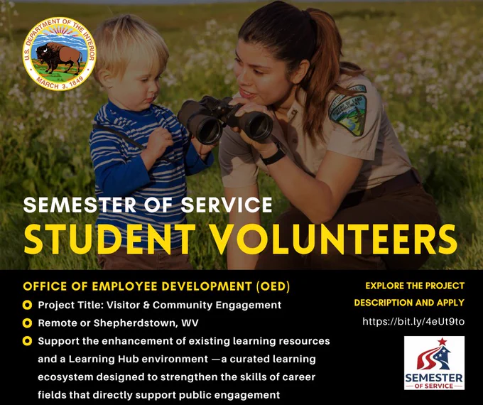 A park ranger shows binoculars to a young boy in a field of wildflowers. Text promotes a community engagement project in Shepherdstown, WV or remote.