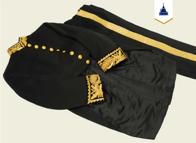 A black tunic and trouser set with gold detailing. 