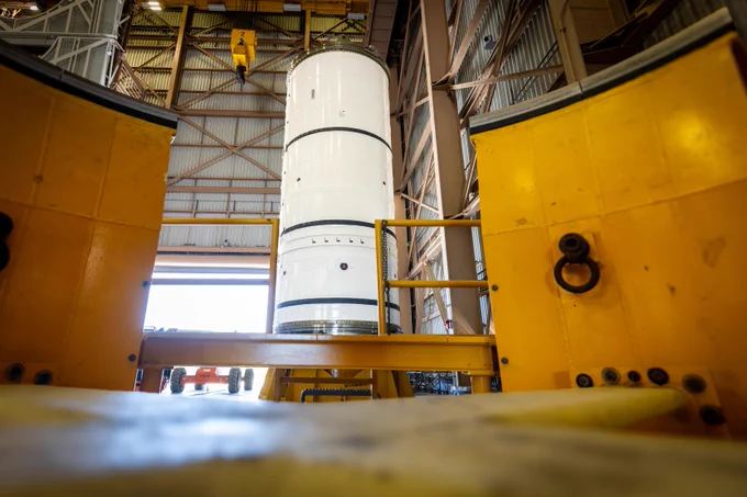 The left-hand forward solid rocket booster segment for NASA\u2019s Artemis III SLS (Space Launch System) rocket is removed from its shipping container ahead of processing inside the Rotation, Processing and Surge Facility at the agency\u2019s Kennedy Space Center in Florida on Wednesday, April 15, 2026. Credit: NASA/Frank Michaux 