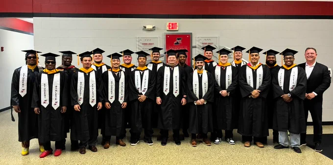 2026 graduates photo with Coach Keevers.