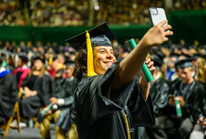 Graduate taking a selfie after crossing the stage