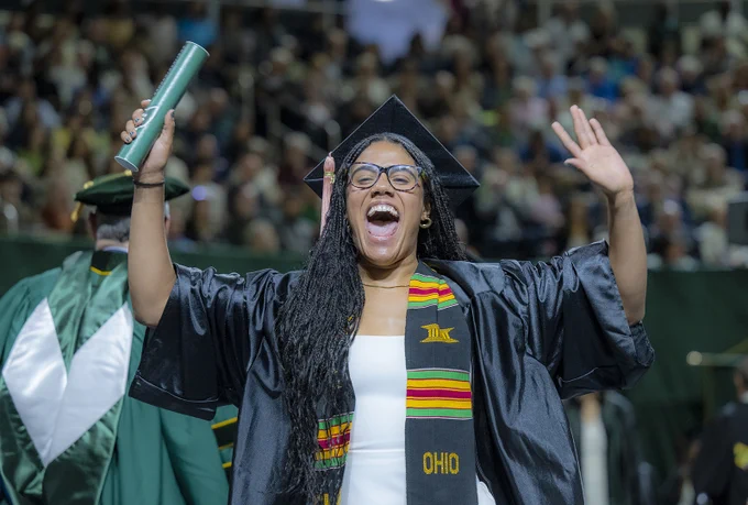 Graduate celebrating as they walk off stage