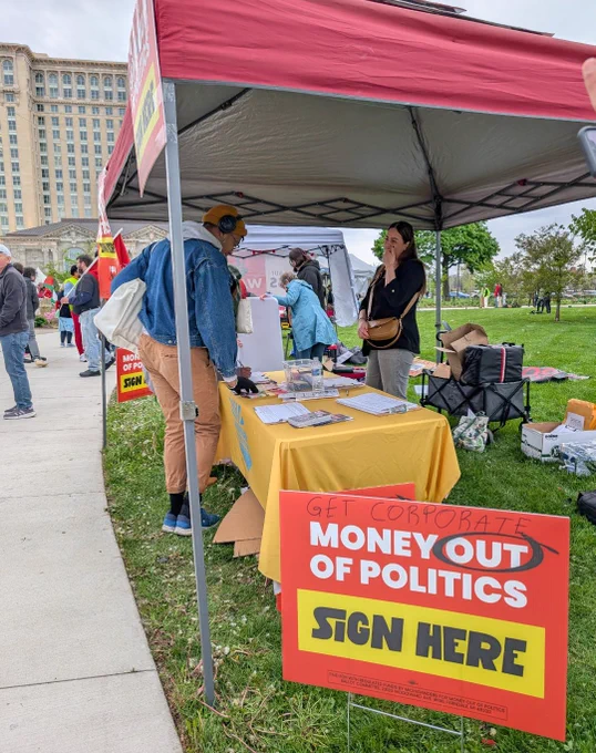 Tabling with sign "get corporate money out of politics - sign here"