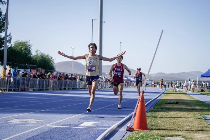 Sharvin crosses the finish line, beating a Chico State Challenger by a couple strides.