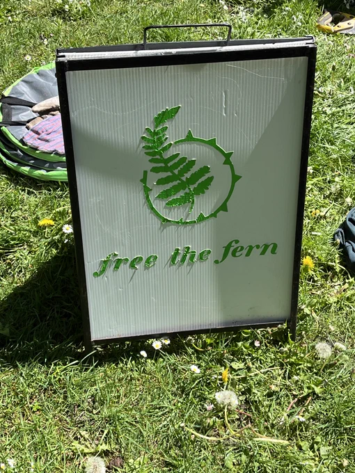 A white and green sign that says 'free the fern'