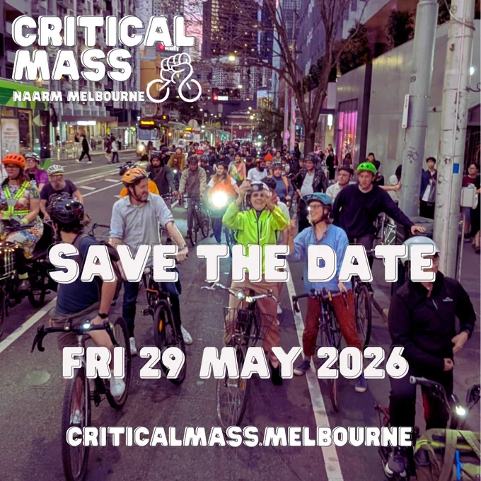 Large group of riders on bikes and e-scooters on a Melbourne city street at dusk facing the camera