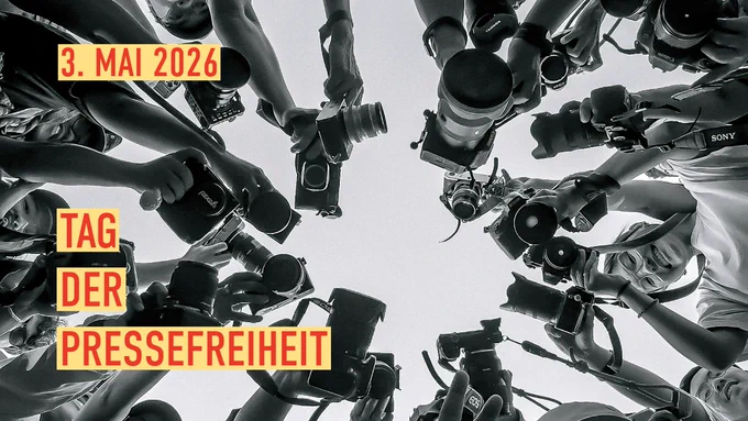 Schwarzweiß-Fotografie, die eine Gruppe von Fotografen und Kameras zeigt.